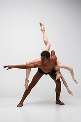 Image showing Couple of ballet dancers posing over gray background