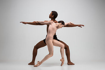 Image showing Couple of ballet dancers posing over gray background