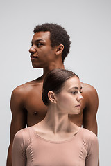 Image showing Couple of ballet dancers posing over gray background