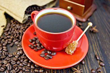 Image showing Coffee in red cup with sugar and bag on board