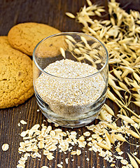 Image showing Bran small oat in glass with cookies on board