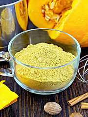 Image showing Flour pumpkin in glass cup with sieve on board