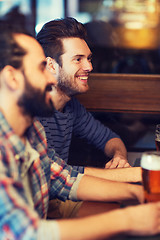 Image showing happy male friends drinking beer at bar or pub