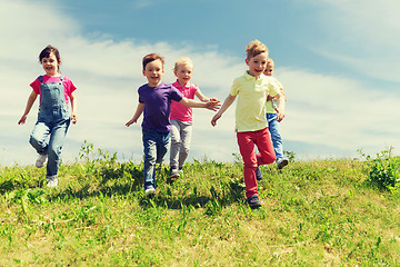 Image showing group of happy kids running outdoors