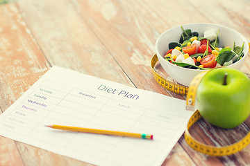 Image showing close up of diet plan and food on table