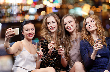 Image showing women with champagne taking selfie at night club