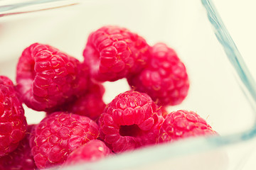 Image showing close up of ripe red raspberries in glass