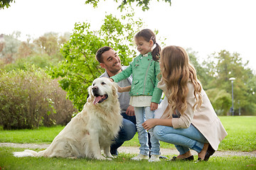 Image showing happy family with labrador retriever dog in park
