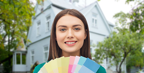 Image showing smiling young woman with color swatches