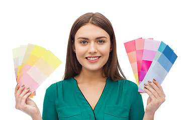 Image showing smiling young woman with color swatches