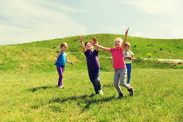 Image showing group of happy kids running outdoors