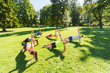 Image showing group of happy friends exercising outdoors