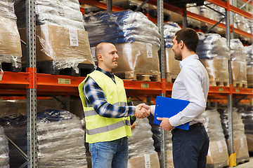 Image showing worker and businessmen with clipboard at warehouse