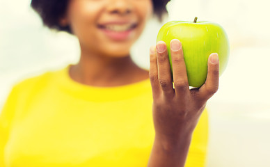 Image showing happy african american woman with green apple