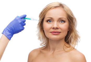 Image showing happy woman face and beautician hand with syringe