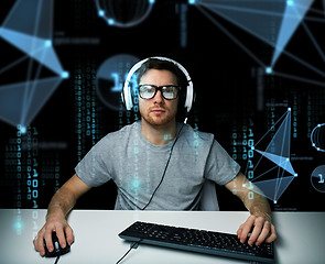 Image showing man in headset hacking computer or programming