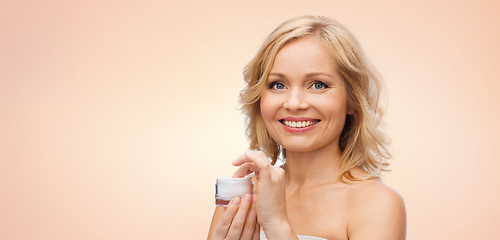 Image showing happy woman with cream jar