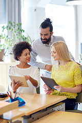 Image showing happy creative team with tablet pc in office