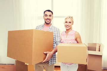 Image showing couple with big cardboard boxes moving to new home