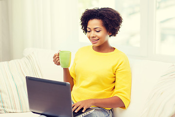 Image showing happy african american woman with laptop at home