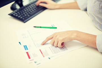 Image showing close up of woman hands with papers and computer