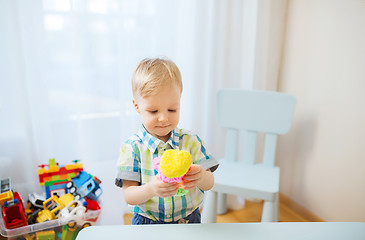 Image showing happy little baby boy with ball clay at home