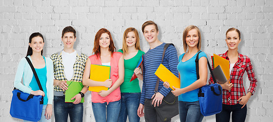 Image showing group of teenage students with folders and bags