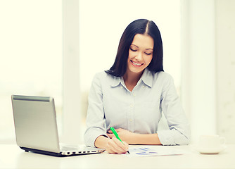 Image showing smiling businesswoman or student with laptop