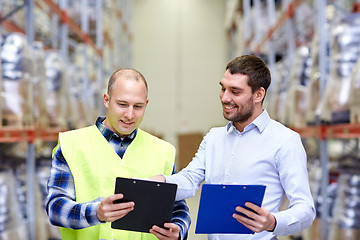 Image showing worker and businessmen with clipboard at warehouse