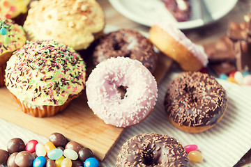 Image showing close up of glazed donuts and sweets on table