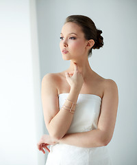 Image showing beautiful asian woman with golden bracelet