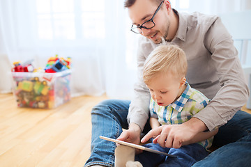 Image showing father and son with tablet pc playing at home