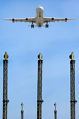 Image showing Plane over lights in airport