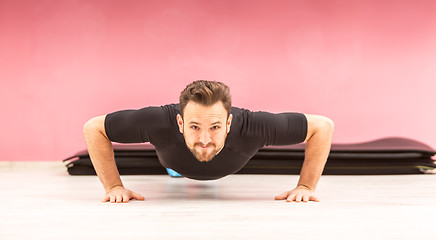 Image showing Portrait of a Young Man Doing Pushups