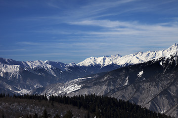 Image showing View on snowy mountains in sun windy day