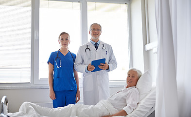 Image showing doctor and nurse visiting senior woman at hospital