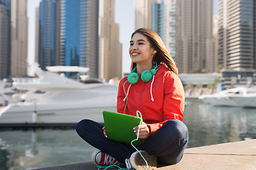 Image showing happy young woman with tablet pc and headphones