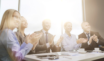 Image showing business team with laptop clapping hands