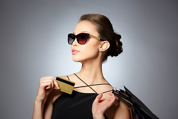 Image showing happy woman with credit card and shopping bags