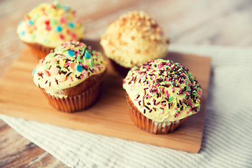 Image showing close up of glazed cupcakes or muffins on table