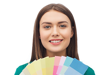 Image showing smiling young woman with color swatches