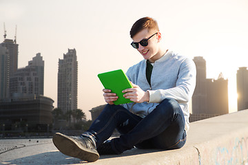 Image showing happy young man with tablet pc in city