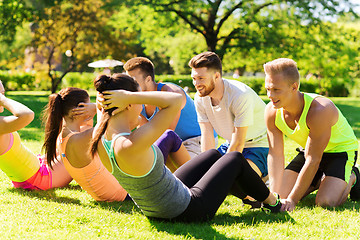 Image showing group of friends or sportsmen exercising outdoors