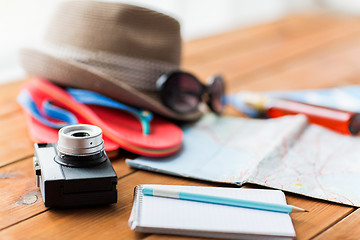 Image showing close up of camera, notepad and travel stuff