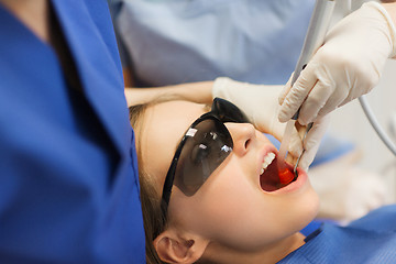 Image showing female dentists treating patient girl teeth