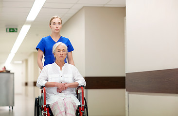 Image showing nurse with senior woman in wheelchair at hospital