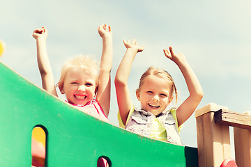 Image showing happy girls waving hands on children playground