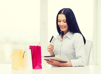 Image showing smiling woman with blank screen tablet pc