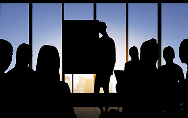 Image showing business people silhouettes at meeting in office