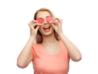 Image showing happy young woman with red heart shapes on eyes